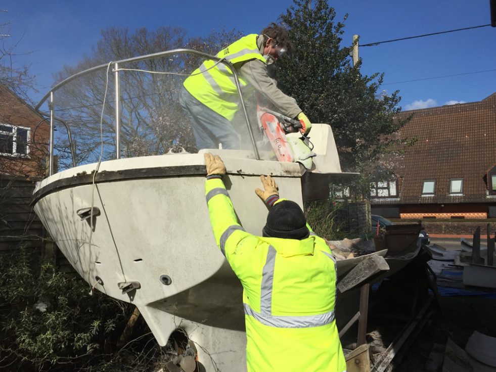 Boat Recycling - Fibreglass Yacht being cut up for recycling.